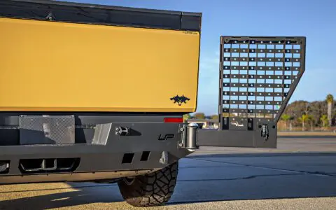 Dune Sand Vinyl Wrapped Cybertruck with Carbon Fiber Fenders, INVINCIBLE Rear Steel Bumper with Swing Arms on 18 inch UP-03 Forged Beadlock Wheels in Satin Titanium