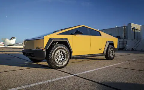 Dune Sand Vinyl Wrapped Cybertruck with Carbon Fiber Fenders, INVINCIBLE Rear Steel Bumper with Swing Arms on 18 inch UP-03 Forged Beadlock Wheels in Satin Titanium