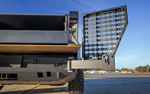 Dune Sand Vinyl Wrapped Cybertruck with Carbon Fiber Fenders, INVINCIBLE Rear Steel Bumper with Swing Arms on 18 inch UP-03 Forged Beadlock Wheels in Satin Titanium