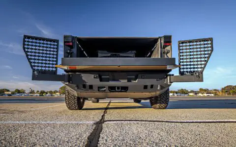 Dune Sand Vinyl Wrapped Cybertruck with Carbon Fiber Fenders, INVINCIBLE Rear Steel Bumper with Swing Arms on 18 inch UP-03 Forged Beadlock Wheels in Satin Titanium