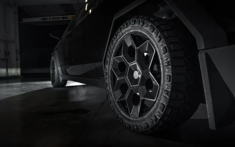 Close-up of 24-inch Cybrhex Wheel in Satin Black on a Tesla Cybertruck, featuring hexagonal design and rugged BFG off-road tires, highlighting Unplugged Performance’s signature styling.