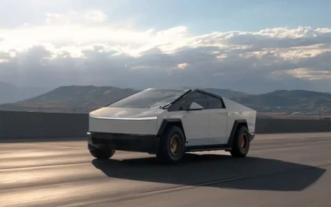 Rolling shot of a White Tesla Cybertruck with custom-finished Satin Bronze UP-03 Beadlock Forged Wheels by Unplugged Performance,